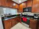 Kitchen features dark wood cabinets, granite counters & stainless steel appliances at 5434 River Rock Rd, Lakeland, FL 33809