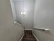 Interior staircase with carpeted steps and simple light fixture at 5434 River Rock Rd, Lakeland, FL 33809