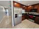 Modern kitchen with stainless steel refrigerator and dark wood cabinets at 5434 River Rock Rd, Lakeland, FL 33809