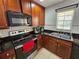 Updated kitchen with stainless steel appliances and dark wood cabinets at 5434 River Rock Rd, Lakeland, FL 33809