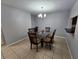 Dining room with a glass-top table, six chairs, and a chandelier at 5434 River Rock Rd, Lakeland, FL 33809