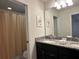 Bathroom with double vanity, shower, and toilet at 8940 Sydney Ave, Kissimmee, FL 34747