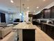 Open concept kitchen with island and stainless steel appliances at 8940 Sydney Ave, Kissimmee, FL 34747