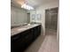 Double vanity bathroom with granite countertop and shower at 8940 Sydney Ave, Kissimmee, FL 34747