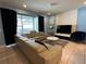 Spacious living room featuring a large sectional sofa and flat-screen TV at 8940 Sydney Ave, Kissimmee, FL 34747