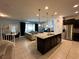 Open kitchen with island, granite countertops, and stainless steel appliances at 8940 Sydney Ave, Kissimmee, FL 34747