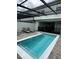 Private heated pool with covered patio and outdoor furniture at 8940 Sydney Ave, Kissimmee, FL 34747