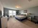 Spacious main bedroom with large bed and plenty of natural light at 8940 Sydney Ave, Kissimmee, FL 34747