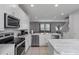 Kitchen boasts stainless steel appliances and an island at 7481 Marker Ave, Kissimmee, FL 34747