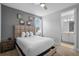 Main bedroom with ensuite bathroom access and a ceiling fan at 7481 Marker Ave, Kissimmee, FL 34747