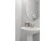 Small bathroom with pedestal sink and large mirror at 7481 Marker Ave, Kissimmee, FL 34747