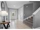 Bright entryway with tile flooring, staircase, and console table at 7481 Marker Ave, Kissimmee, FL 34747