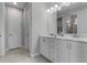 Double vanity bathroom with marble countertop at 7481 Marker Ave, Kissimmee, FL 34747