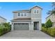 Two-story home with gray siding and a two-car garage at 7481 Marker Ave, Kissimmee, FL 34747