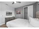 Bedroom with dresser, TV, and sliding door to closet at 7481 Marker Ave, Kissimmee, FL 34747