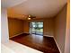 Living room with wood-look floors and view of kitchen at 180 Waterfall Way # 203, Altamonte Springs, FL 32714