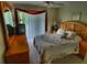 Comfortable bedroom with wooden furniture and a sliding glass door to a private balcony at 8516 Crystal Cove Loop, Kissimmee, FL 34747