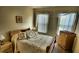 Cozy bedroom with wooden furniture and large windows at 8516 Crystal Cove Loop, Kissimmee, FL 34747