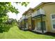 Townhomes with balconies and patios overlooking a green lawn at 8516 Crystal Cove Loop, Kissimmee, FL 34747