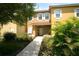 Inviting two-story townhome with landscaped walkway and lush greenery at 8516 Crystal Cove Loop, Kissimmee, FL 34747