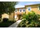 Charming townhome exterior with lush landscaping and a welcoming entrance at 8516 Crystal Cove Loop, Kissimmee, FL 34747