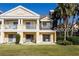 Inviting exterior of a two-story townhome with a landscaped lawn at 1304 Seven Eagles Ct # 1304, Reunion, FL 34747