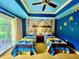Twin bedroom with Minions-themed decor and sliding glass doors at 1304 Seven Eagles Ct # 1304, Reunion, FL 34747