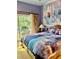 Bright bedroom featuring a Frozen mural and sliding door access to balcony at 1304 Seven Eagles Ct # 1304, Reunion, FL 34747