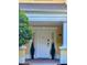 Townhouse entrance with white door and landscaping at 1304 Seven Eagles Ct # 1304, Reunion, FL 34747