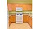 Well-equipped kitchen with light wood cabinets and granite countertops at 1304 Seven Eagles Ct # 1304, Reunion, FL 34747