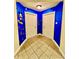 Hallway with blue walls and tiled floor, featuring playful Mickey Mouse decor at 1304 Seven Eagles Ct # 1304, Reunion, FL 34747