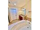 Relax in this updated bathroom, featuring a large soaking tub and modern vanity at 1304 Seven Eagles Ct # 1304, Reunion, FL 34747