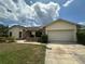 Single-story home with attached garage and landscaped yard at 368 Fairgreen Pl, Casselberry, FL 32707