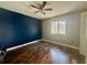 Bedroom with dark blue accent wall and hardwood floors at 368 Fairgreen Pl, Casselberry, FL 32707
