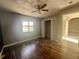 Bedroom with hardwood floors, window, and access to hallway at 368 Fairgreen Pl, Casselberry, FL 32707