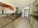 Modern kitchen with granite countertops and stainless steel appliances at 368 Fairgreen Pl, Casselberry, FL 32707