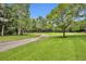Gravel driveway winding through a lush green landscape at 1709 Onondaga Dr, Geneva, FL 32732