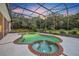 Inviting pool and spa surrounded by a screened enclosure at 1709 Onondaga Dr, Geneva, FL 32732