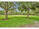 Green pasture landscape with large oak trees at 1709 Onondaga Dr, Geneva, FL 32732