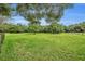 Expansive grassy pasture with trees and wooden fence at 1709 Onondaga Dr, Geneva, FL 32732