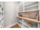 Walk-in pantry with ample shelving, wood countertops, and modern tile accents at 2041 Companero Ave, Orlando, FL 32804