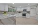 Modern white kitchen with stainless steel appliances and quartz countertops at 1709 Onondaga Dr, Geneva, FL 32732