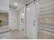 Walk-in pantry with custom shelving and barn door at 1709 Onondaga Dr, Geneva, FL 32732