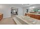 Elegant bathroom with a large soaking tub and views into the bedroom at 1709 Onondaga Dr, Geneva, FL 32732