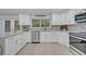 Renovated kitchen, featuring white cabinets, and a large island at 1709 Onondaga Dr, Geneva, FL 32732