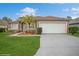 One-story home with a neutral color palette, attached garage and well-maintained lawn at 218 Hillcrest Dr, Davenport, FL 33897