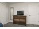 Bedroom with dresser, mirror, and TV at 8951 Bismarck Palm Rd, Kissimmee, FL 34747