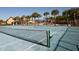 Well-maintained tennis court with surrounding palm trees at 8951 Bismarck Palm Rd, Kissimmee, FL 34747