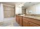 Double vanity bathroom with granite countertops and a bathtub at 8951 Bismarck Palm Rd, Kissimmee, FL 34747