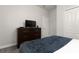 Bedroom with TV, dresser, and full-size bed at 8951 Bismarck Palm Rd, Kissimmee, FL 34747